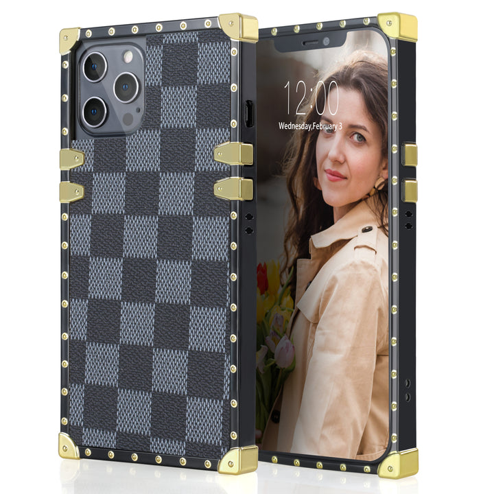 A box-shaped, TPU, iPhone 12 Pro Max case, with gold corner bumpers and gold rivets on its black borders. The case’s back is designed with gray and black checkered boxes.  #color_grey-checkered