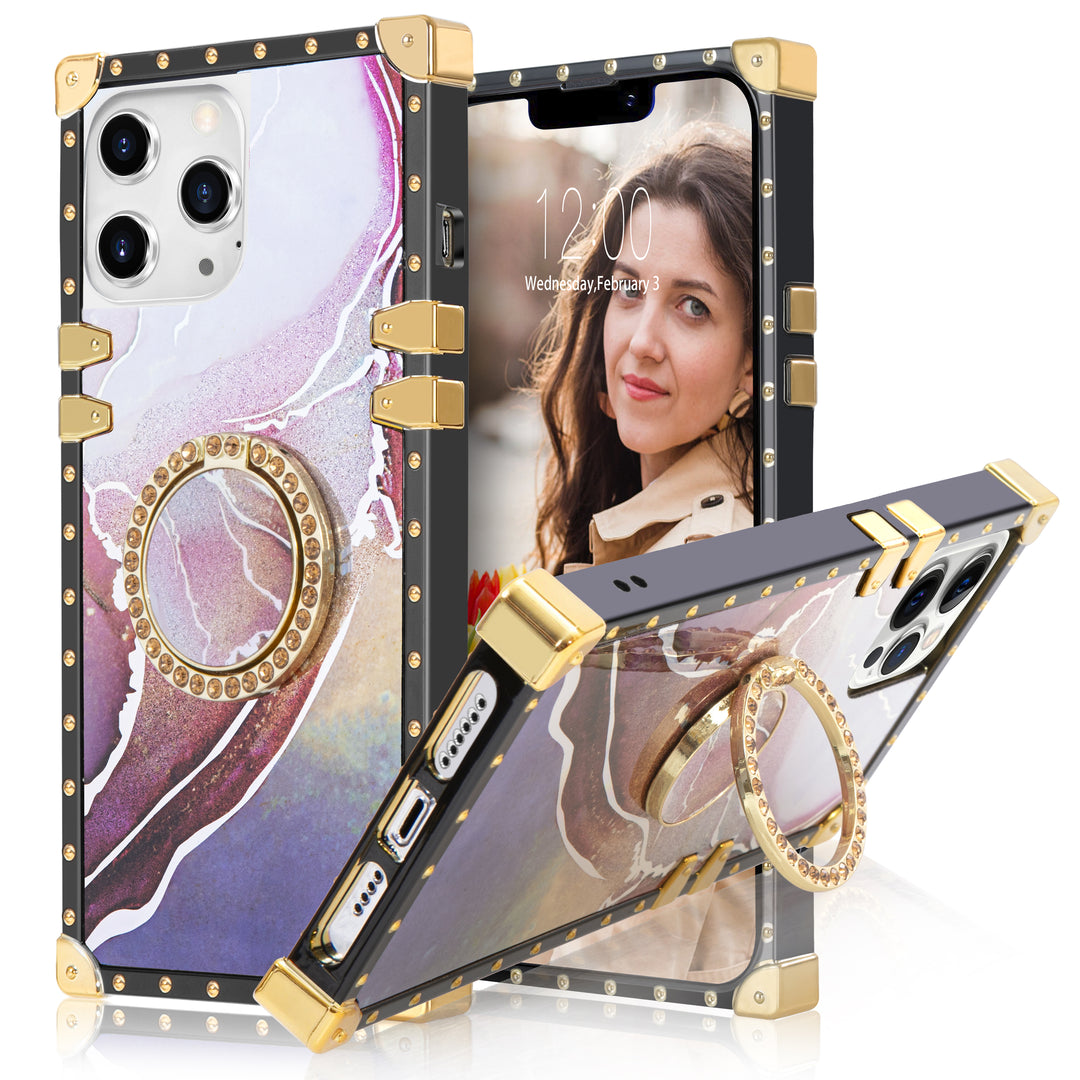 A box-shaped, TPU, iPhone 12 Pro Max case, with gold corner bumpers and gold rivets on its black borders. The case’s back is designed with purple and pink marbling. A gold trim ring doubles as a handle and kickstand for the case. #color_marble-holo-purple-pink
