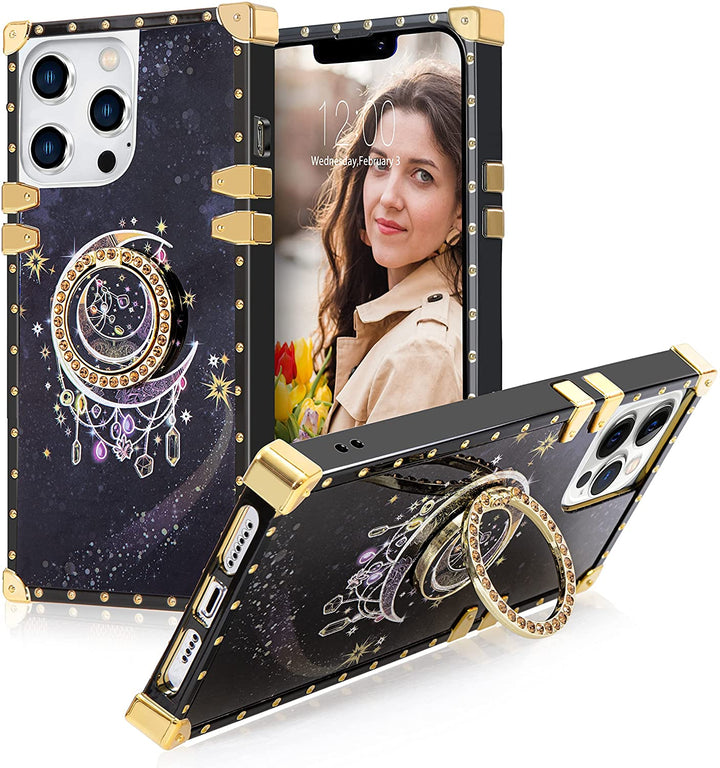A box-shaped TPU case with gold corner bumpers and gold rivets on its black borders. The case’s back design has a golden-half moon outline in a black-blue cosmic backdrop. The case also has a gold ring handle that doubles as a holder and kickstand. #color_black-golden-half-moon