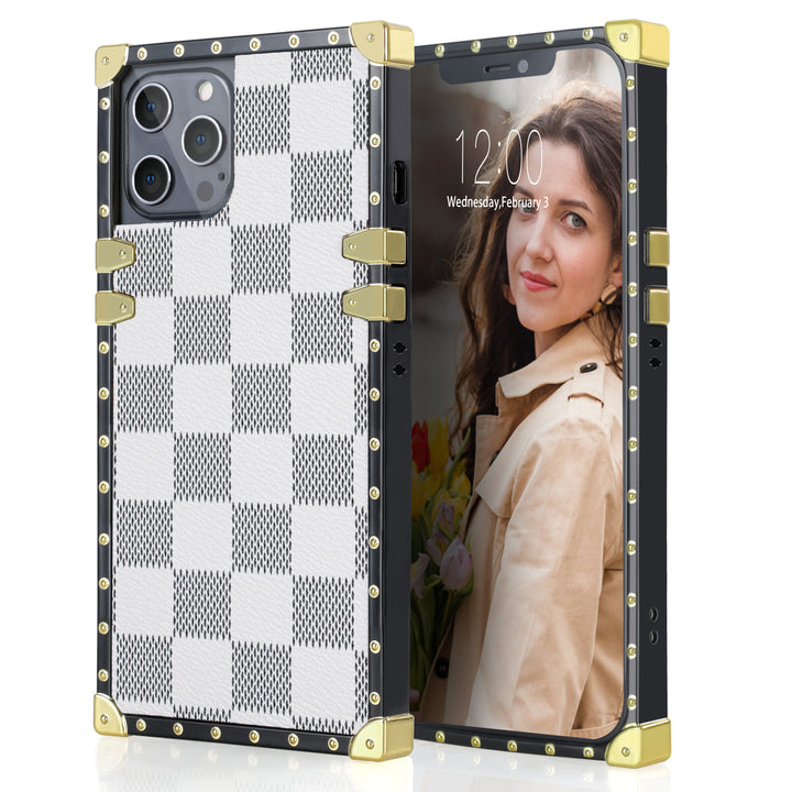 A box-shaped, TPU, iPhone 12 Pro Max case, with gold corner bumpers and gold rivets on its black borders. The case’s back is designed with white and gray checkered boxes. #color_white-checkered